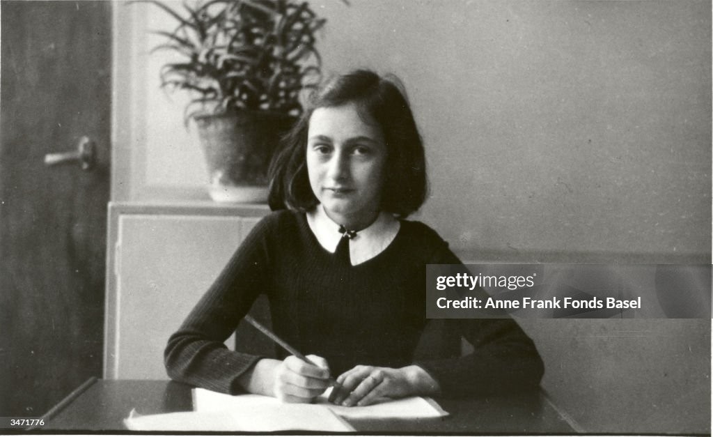 Anne Frank Writes At Her Desk