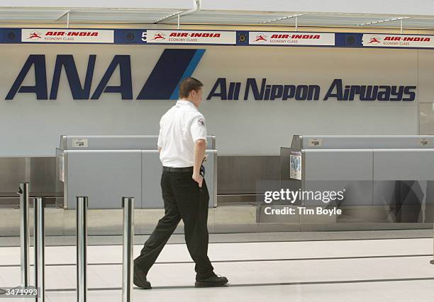 Transportation Security Administration employee walks past the All Nippon Airways ticket counter in the International Terminal at O'Hare...