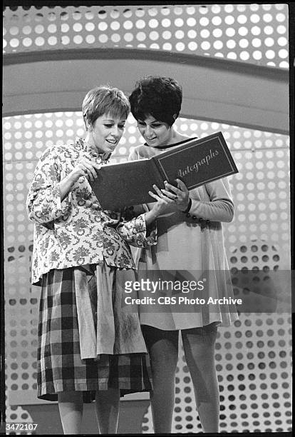 Still from 'The Carol Burnett Show' features American comedienne and actress Carol Burnett and her guest Lainie Kazan who signs Burnett's autograph...