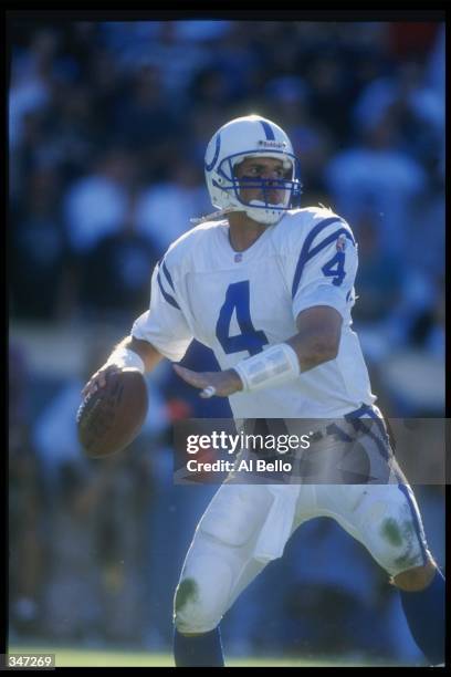 Quarterback Jim Harbaugh of the Indianapolis Colts looks to pass the ball during a game against the Los Angeles Raiders at the Los Angeles Memorial...