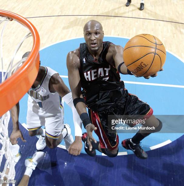 Lamar Odom of the Miami Heat attempts a layup against Jamaal Magloire of the New Orleans Hornets in Game four of the Eastern Conference Quarterfinals...