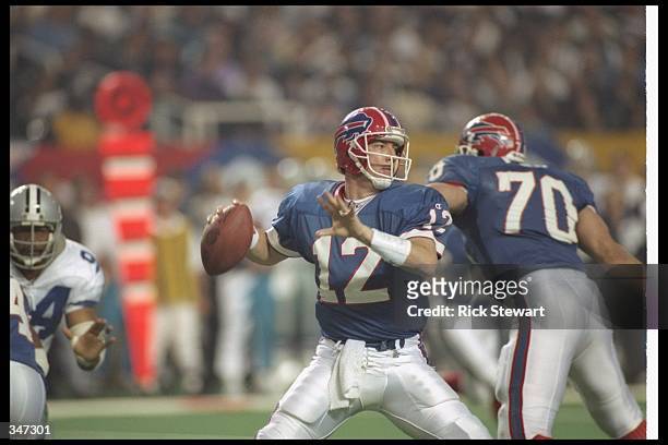 Quarterback Jim Kelly of the Buffalo Bills looks to pass the ball during Super Bowl XXVIII against the Dallas Cowboys at the Georgia Dome in Atlanta,...