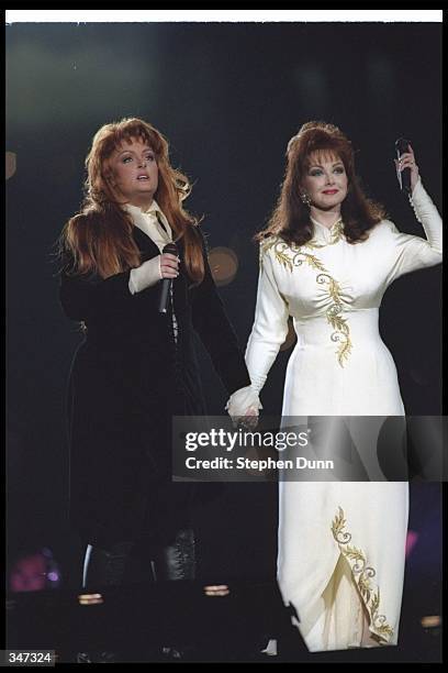 Naomi and Wynonna Judd perform during the halftime show for Super Bowl XXVIII between the Dallas Cowboys and the Buffalo Bills at the Georgia Dome in...