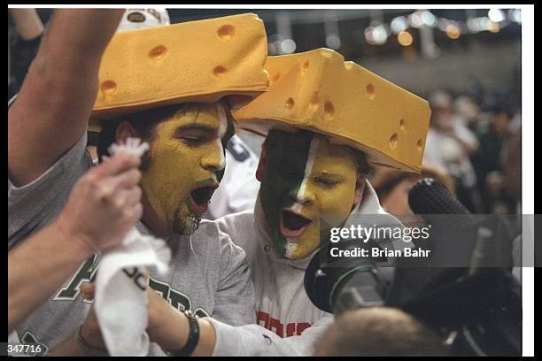 Green Bay Packers fans celebrate during a game against the Dallas Cowboys at Texas Stadium in Irving, Texas. The Cowboys won the game, 21-6.