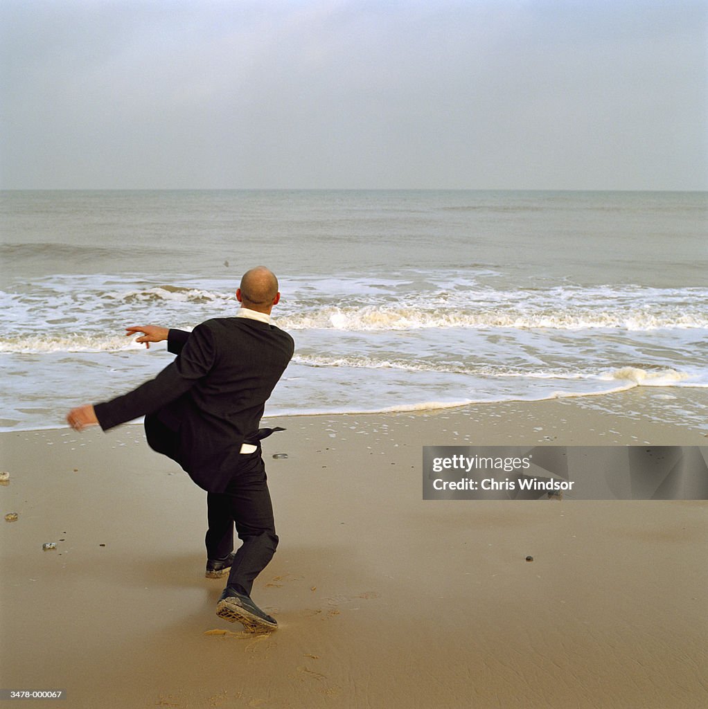 Man Throwing Stones into Sea