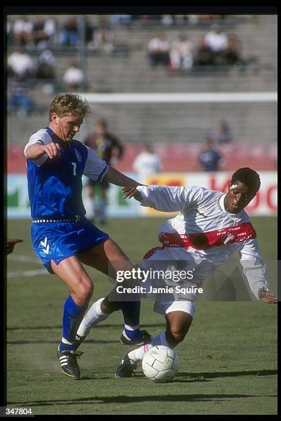 Juan Jose Jayo Legario of Peru and Bjarne Goldbaek of Denmark fight for the ball during an US Cup game at the Rose Bowl in Pasadena, California....