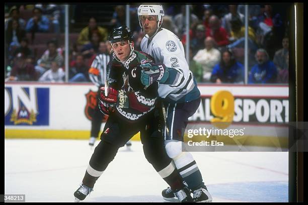 Leftwinger Keith Tkachuk of the Phoenix Coyotes and Anaheim Mighty Ducks defenseman Bobby Dollas tangle up during a game at Arrowhead Pond in...