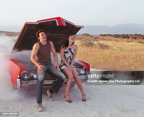 couple sitting on automobile - short skirts in cars stock-fotos und bilder
