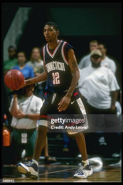 Guard Richard Hamilton of the Connecticut Huskies moves the ball during a game against the Miami Hurricanes at the Miami Arena in Miami, Florida....