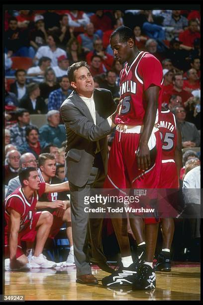 Rebels head coach Bill Bayno confers with center Keon Clark during a game against the Fresno State Bulldogs at Selland Arena in Fresno, California....