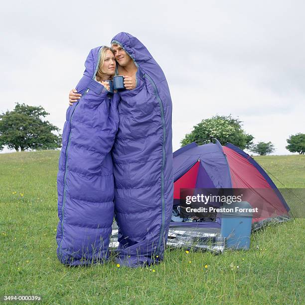 couple in sleeping bags hug - saco de dormir fotografías e imágenes de stock