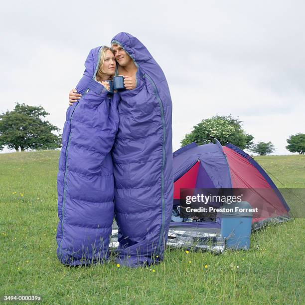 couple in sleeping bags hug - couple camping stock pictures, royalty-free photos & images