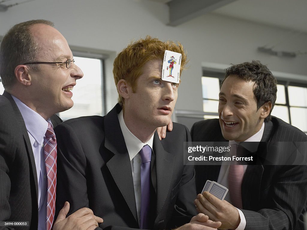 Businessman With Card on Head