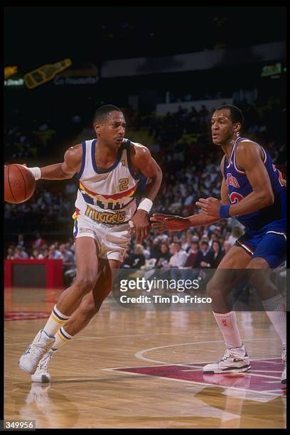 Guard Alex English of the Denver Nuggets moves the ball during a game versus the Cleveland Cavaliers at the McNichols Sports Arena in Denver,...