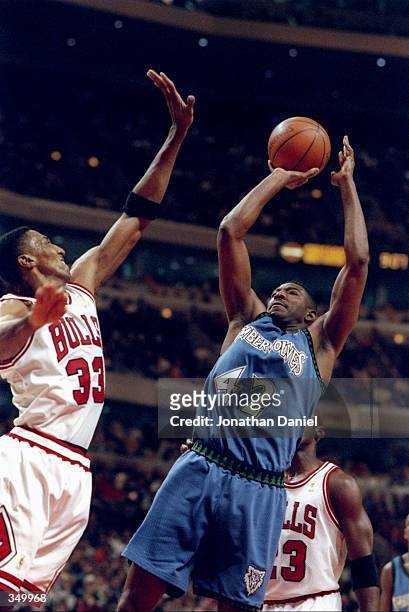 Forward Sam Mitchell of the Minnesota Timberwolves goes up for two as Chicago Bulls guard Scottie Pippen covers him during a game at the United...