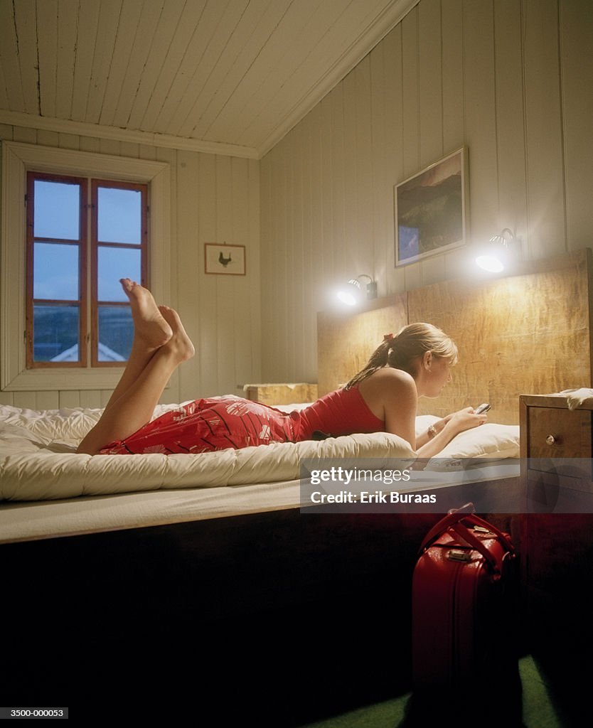 Woman Lying on Hotel Bed