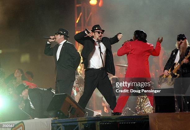 Dan Aykroyd, James Belushi, and James Brown perform during the half-time show for Super Bowl XXXI between the New England Patriots and the Green Bay...