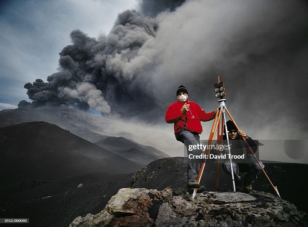 Two Men Examine Volcano