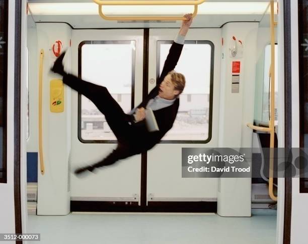 commuter knocked off feet - columpiarse fotografías e imágenes de stock