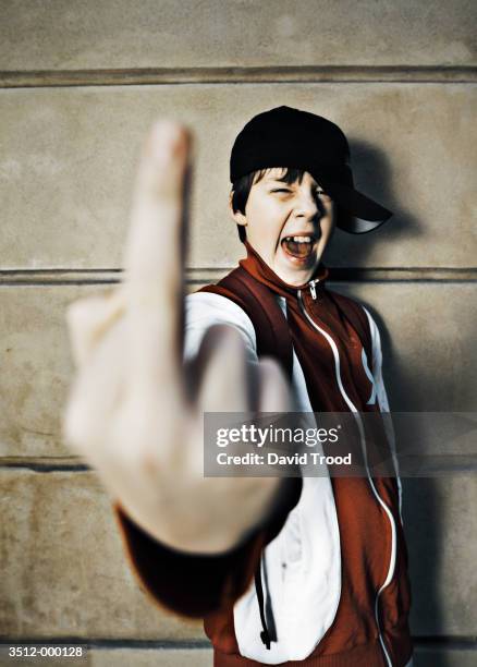 boy making rude gesture - boy tracksuit stock pictures, royalty-free photos & images