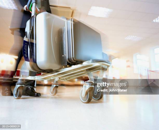 suitcases on luggage cart - luggage trolley stock pictures, royalty-free photos & images