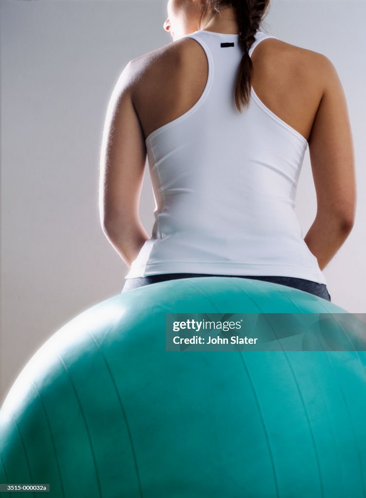 Woman Sitting on Pilates Ball