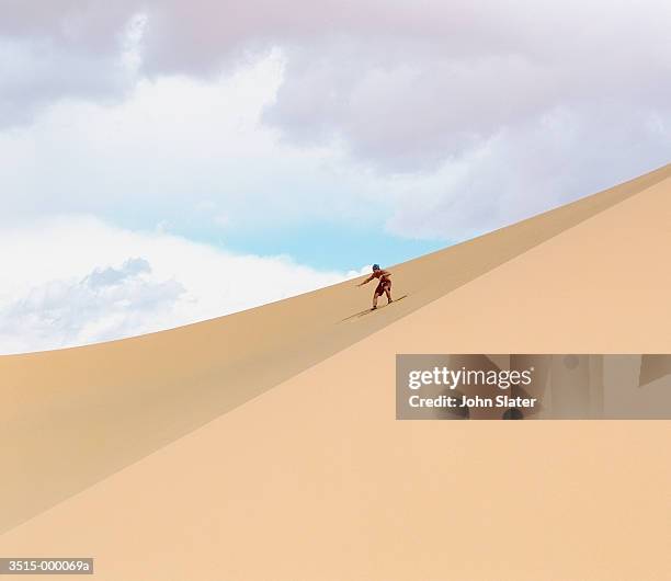 sandboarder on dune - sand boarding stock pictures, royalty-free photos & images