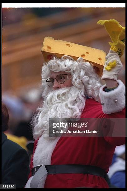 Green Bay Packers fan dressed as Santa Claus celebrates during a game against the Minnesota Vikings at Lambeau Field in Green Bay, Wisconsin. The...
