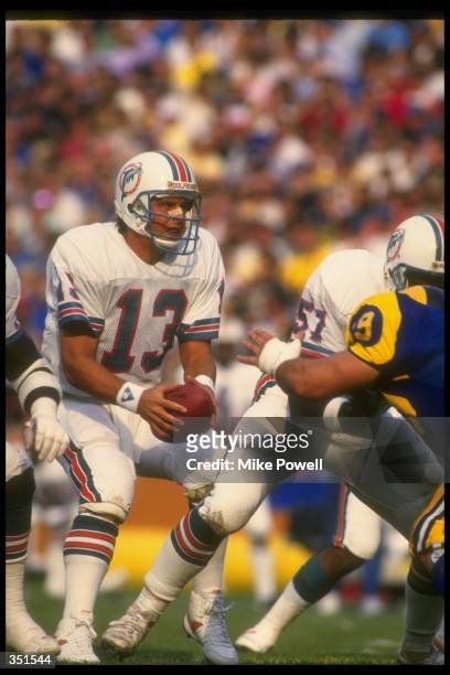 Quarterback Dan Marino of the Miami Dolphins looks to pass the ball during a game against the Los Angeles Rams at Anaheim Stadium in Anaheim,...
