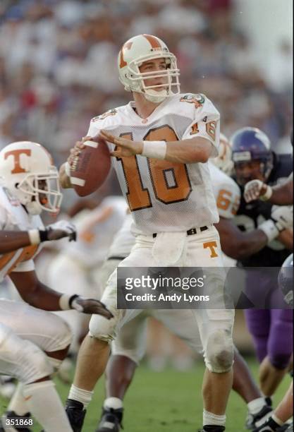 Quarterback Peyton Manning of the Tennessee Volunteers looks to pass the ball during the Citrus Bowl against the Northwestern Wildcats at the Citrus...
