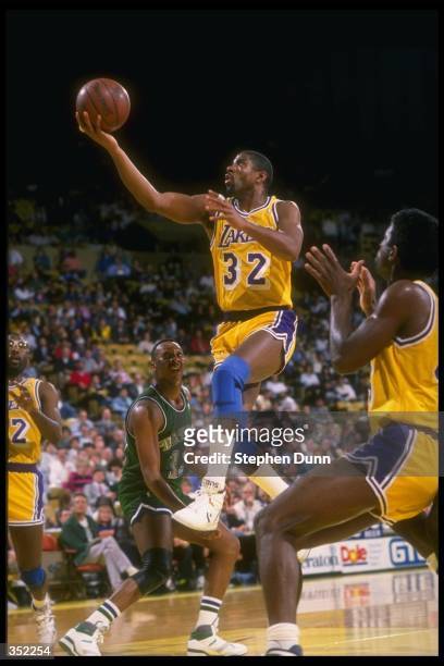 Guard Magic Johnson of the Los Angeles Lakers goes up for two during a game versus the Dallas Mavericks at the Great Western Forum in Inglewood,...
