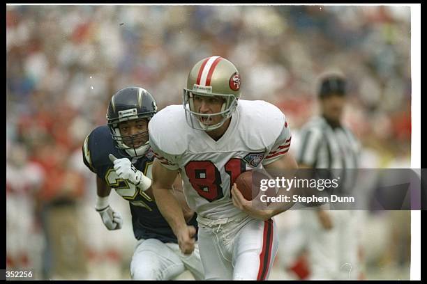 Wide receiver Ed McCaffrey of the San Francisco 49ers moves the ball during a game against the San Diego Chargers at Jack Murphy Stadium in San...