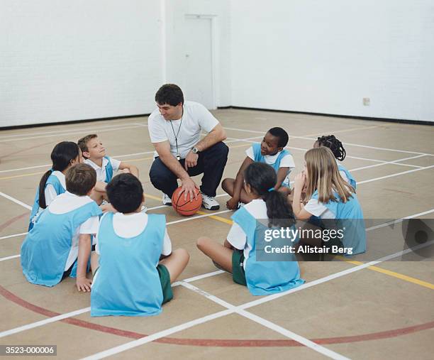 sports coach and children - physical education stock pictures, royalty-free photos & images