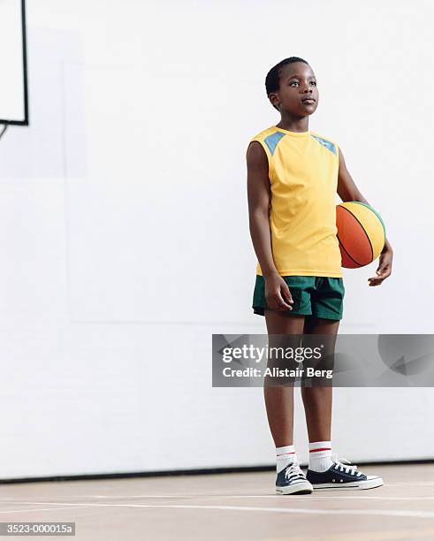 boy with basketball - black shorts stockfoto's en -beelden