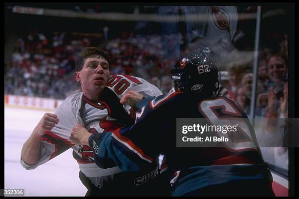 Defenseman Lyle Odelein of the New Jersey Devils and New York Islanders player Steve Webb fight during a game at the Continental Airlines Arena in...