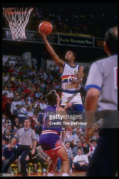 Guard Fat Lever of the Denver Nuggets goes up for two over guard Jeff Hornacek of the Phoenix Suns during a Nuggets game versus the Suns at the...