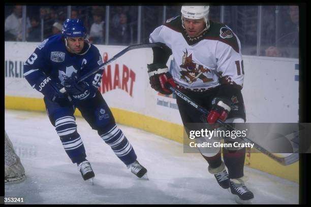 Center Doug Gilmour of the Toronto Maple Leafs and Phoenix Coyotes defenseman Brad McCrimmon moves down the ice during a game at the America West...