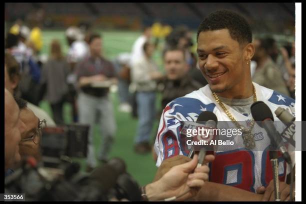 Wide receiver Terry Glenn of the New England Patriots gets interviewed during Media Day for Super Bowl XXXI against the Green Bay Packers at the...