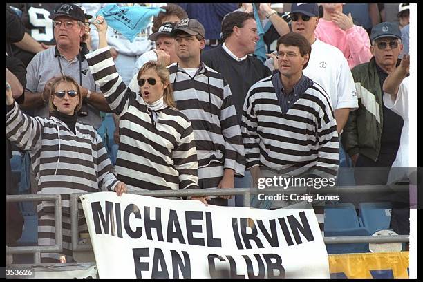 Appropriately-dressed Michael Irvin "fans" look on during a playoff game between the Dallas Cowboys and the Carolina Panthers at Ericsson Stadium in...