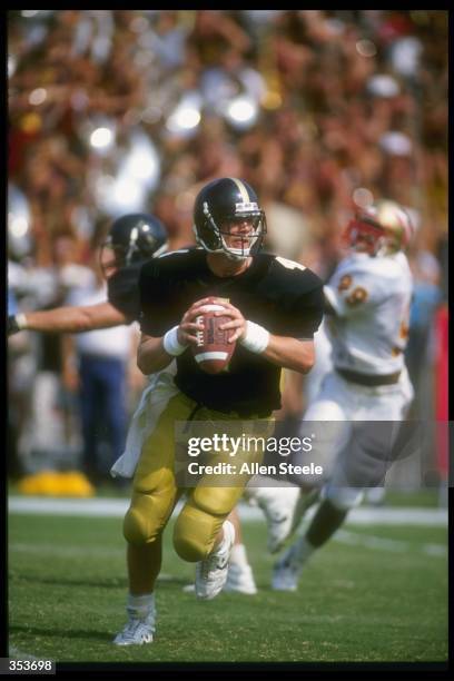 Quarterback Brett Favre of the Southern Mississippi Golden Eagles looks to pass while rolling out during the Golden Eagles 30-26 victory over the...