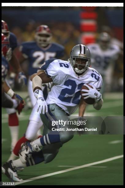 Running back Emmitt Smith of the Dallas Cowboys moves the ball during Super Bowl XXVIII against the Buffalo Bills at the Georgia Dome in Atlanta,...