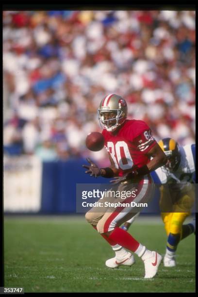 Wide receiver Jerry Rice of the San Francisco 49ers runs with the ball during a game against the Los Angeles Rams at Candlestick Park in San...