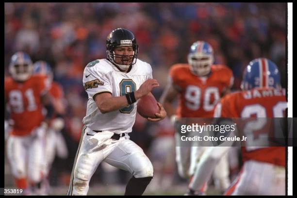 Quarterback Mark Brunell of the Jacksonville Jaguars moves the ball during a playoff game against the Denver Broncos at Mile High Stadium in Denver,...