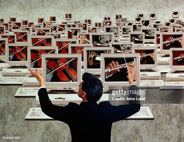 conductor in front of 'orchestra' of computer screens (composite) - trombone stock pictures, royalty-free photos & images