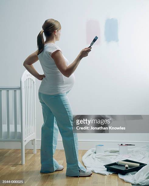 woman painting nursery - baby room stock pictures, royalty-free photos & images