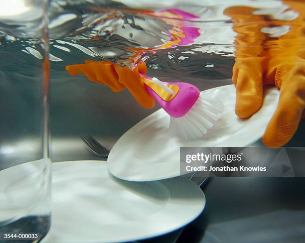 hands in water doing dishes - washing dishes bildbanksfoton och bilder