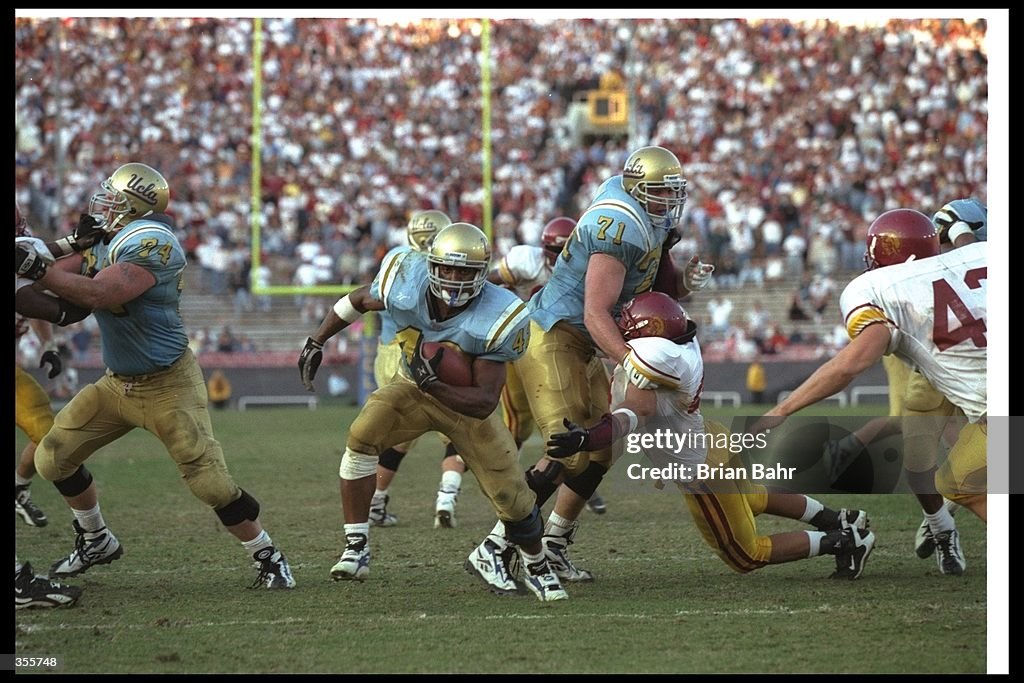 Running back Skip Hicks of the UCLA Bruins runs with the ball into