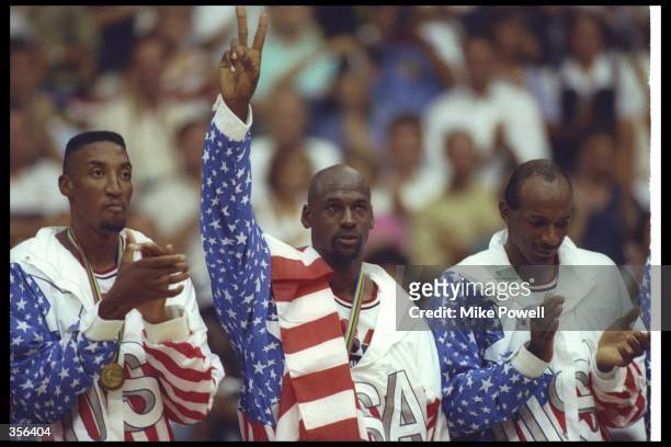 Scottie Pippen, Michael Jordan, and Clyde Drexler of the USA celebrate after winning the gold medal during the Barcelona Olympics in Barcelona,...
