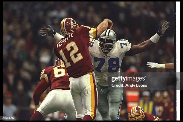 Quarterback Gus Frerotte of the Washington Redskins passes the ball as Dallas Cowboys defensive lineman Leon Lett rushes him during a game at Texas...