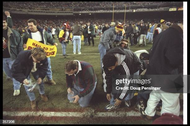 Washington Redskins fans tear up the turf at RFK Stadium in Washington, D. C. After a game against the Dallas Cowboys. The Redskins, playing their...